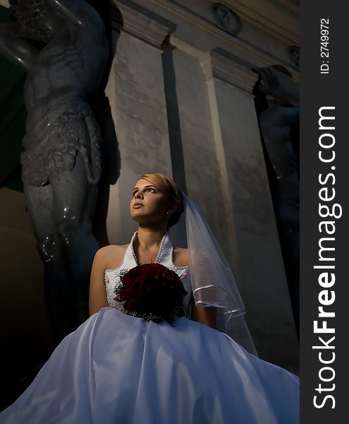 Bride with a bouquet of red roses