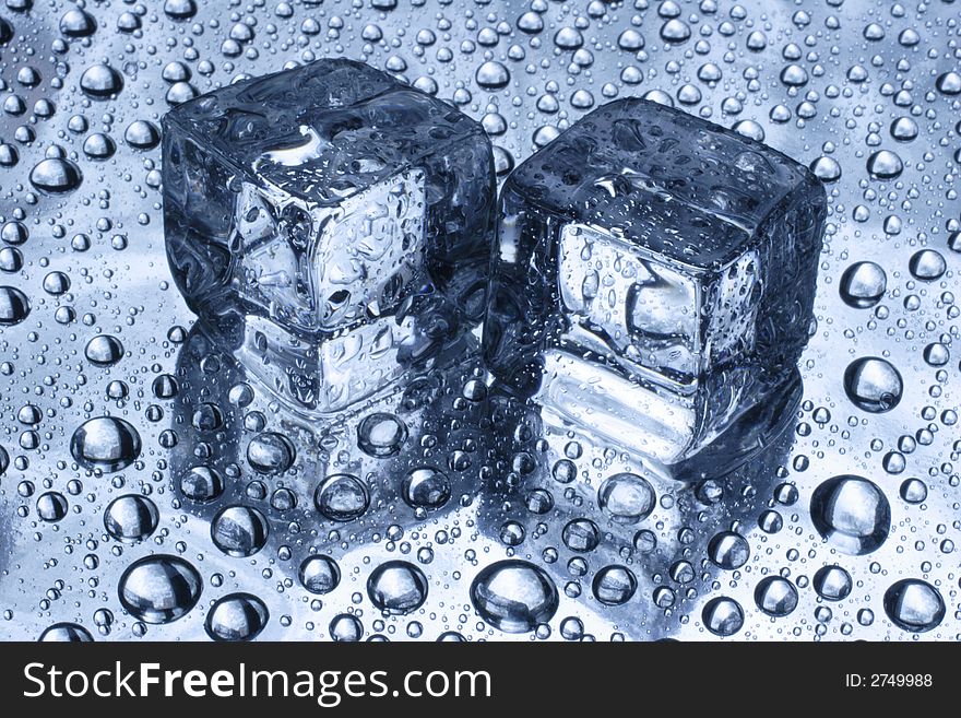 Two pieces of an ice and drop of water