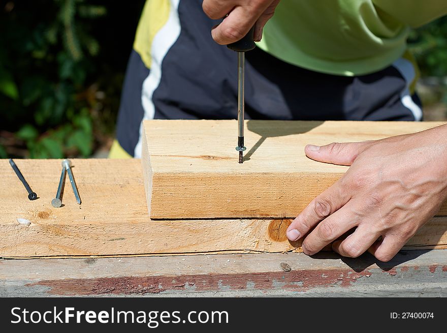 A man with a hammer to drive nails. A man with a hammer to drive nails