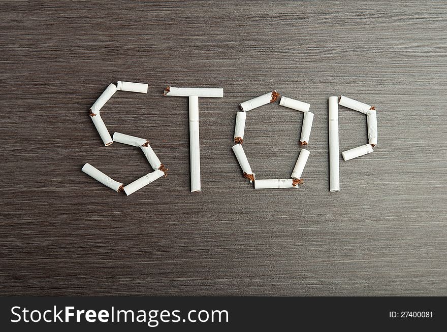 Concept of the dangers of smoking. the word stop of cigarettes. Concept of the dangers of smoking. the word stop of cigarettes