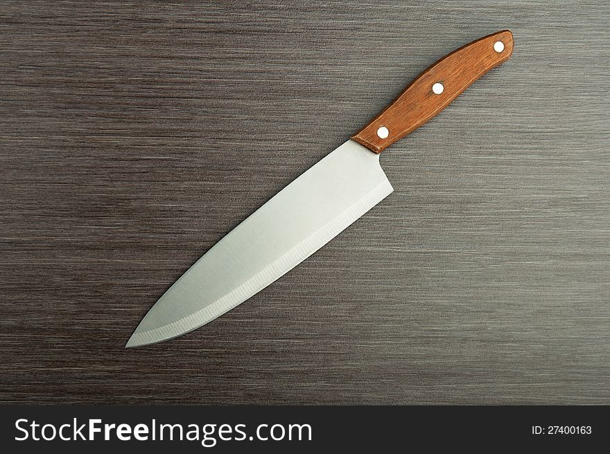 Kitchen knife on  wooden background