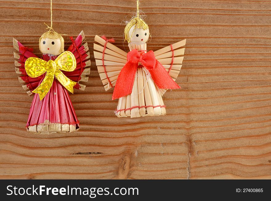 Christmas decoration - two angels on wood background