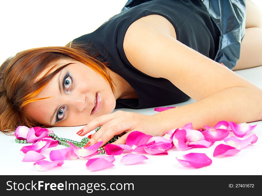 Beautiful girl lying in rose petals