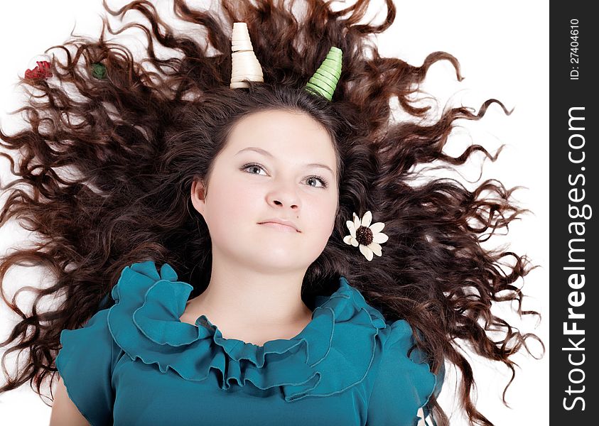 Glamorous portrait of a girl with curly horns on an isolated