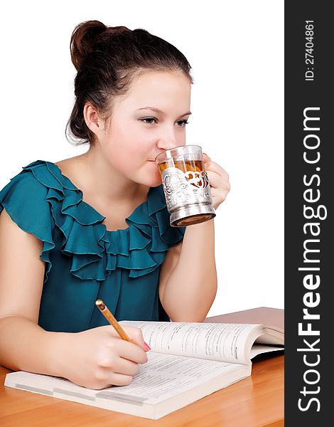 Pretty schoolgirl drinking tea on an isolated white background