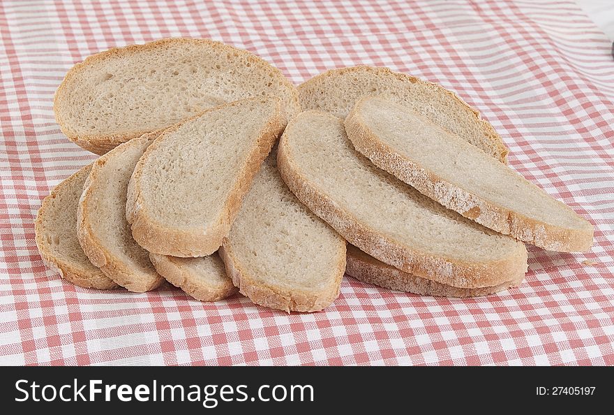 The gray bread cut on pieces on a pink napkin