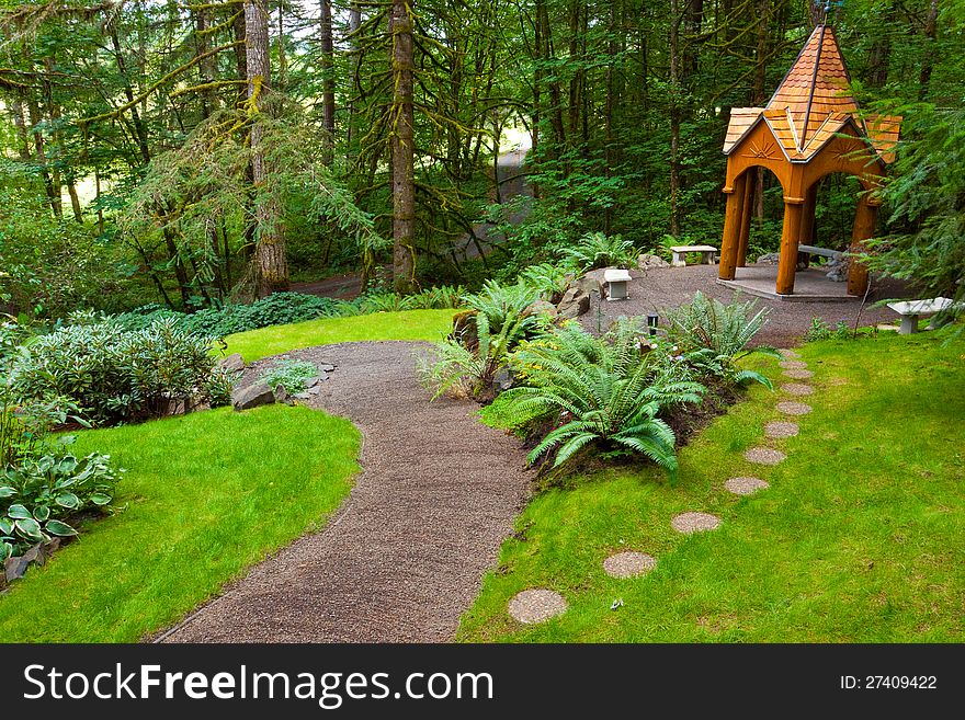 A beautiful path leads to a wooden gazebo in a perfectly manicured green natural garden at an Oregon wedding venue. A beautiful path leads to a wooden gazebo in a perfectly manicured green natural garden at an Oregon wedding venue.