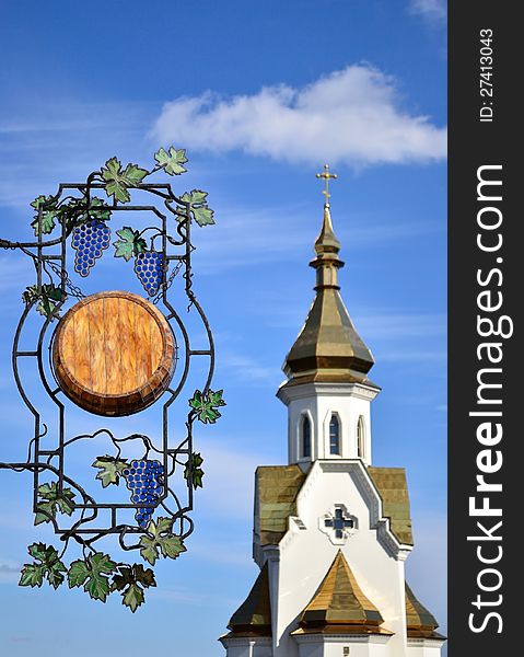 Wooden signboard with forged elements on Ð° church background