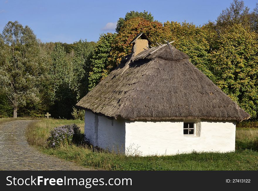 Old ukrainian house with a cross in the background in Pirogovo museum, Kiev, Ukraine