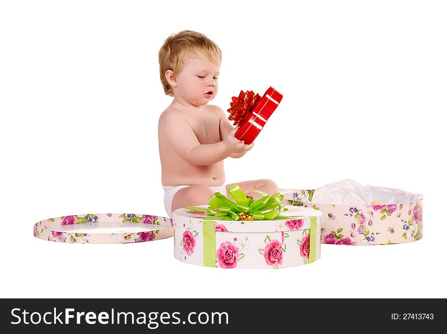 Boy plays with gift boxes isolated on white background