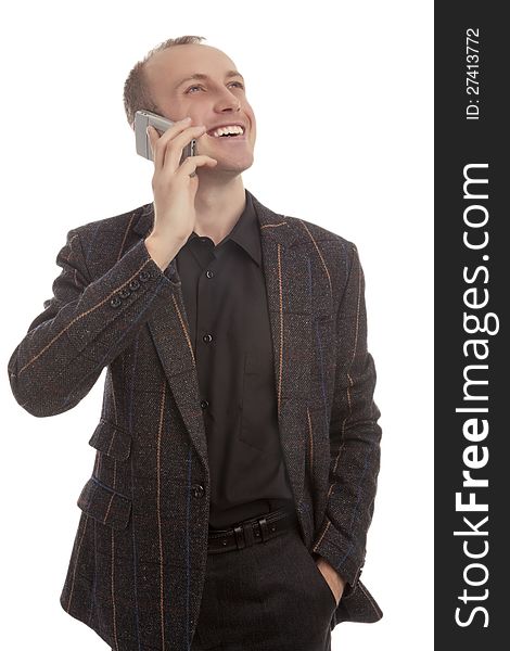 Young man speaking on cellphone and looking against white background. Young man speaking on cellphone and looking against white background