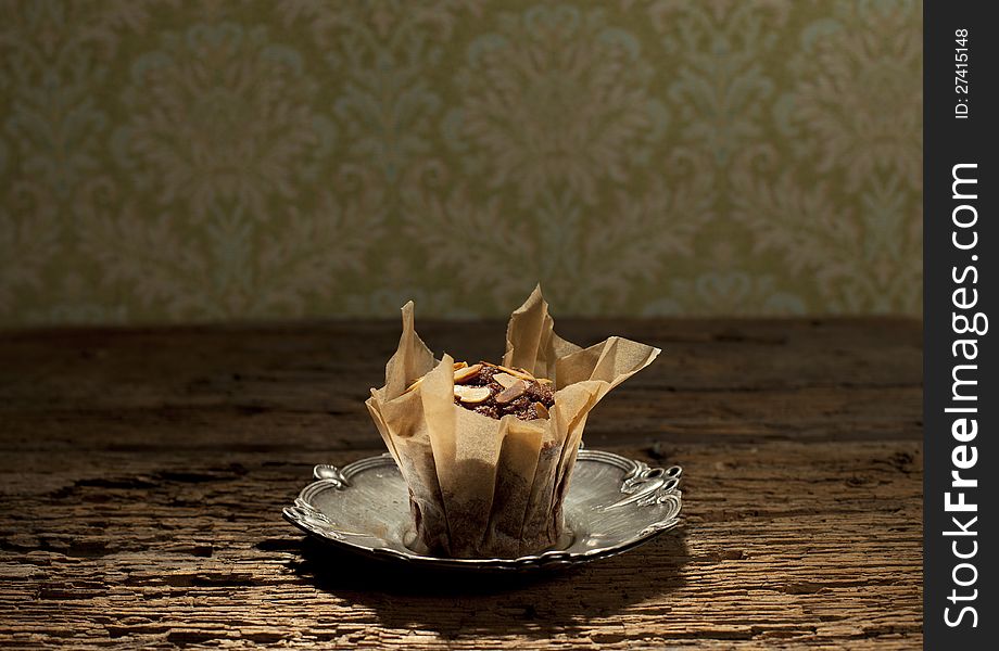 Peanuts with delicious muffin on silver plate