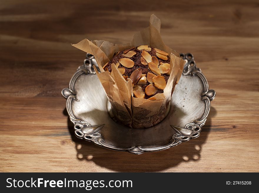 Peanuts with delicious muffin on silver plate. Peanuts with delicious muffin on silver plate