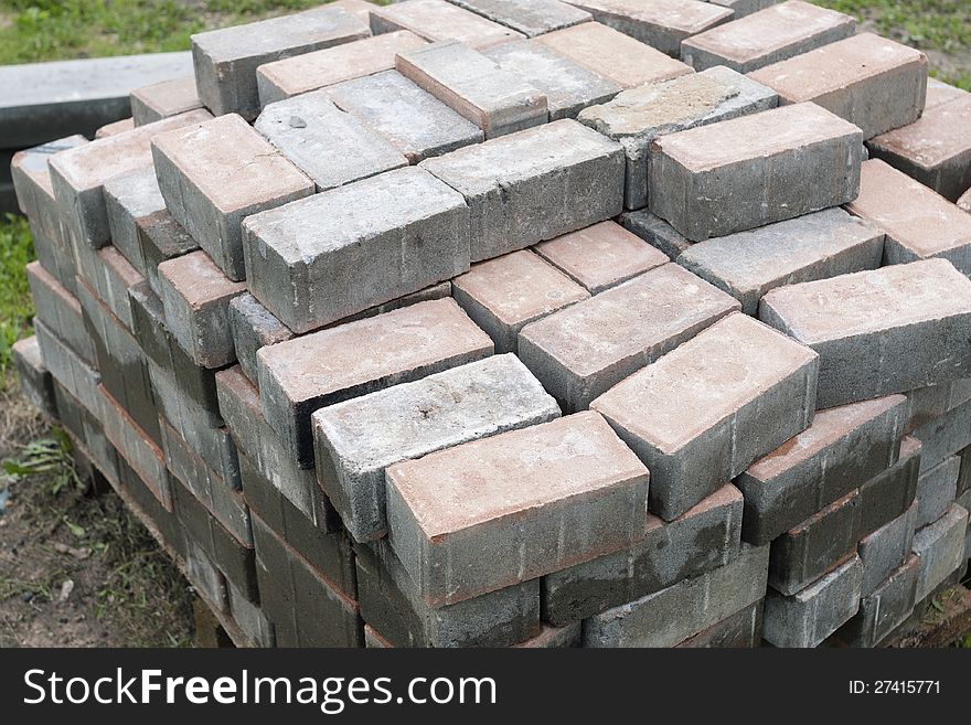 Stack of pavement bricks lays outdoor. Stack of pavement bricks lays outdoor