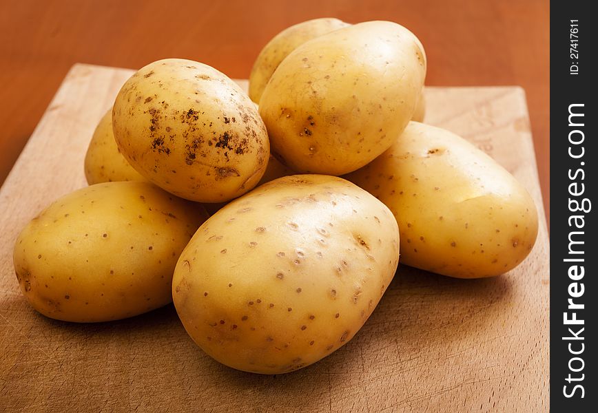 Potatoes close up in wooden background