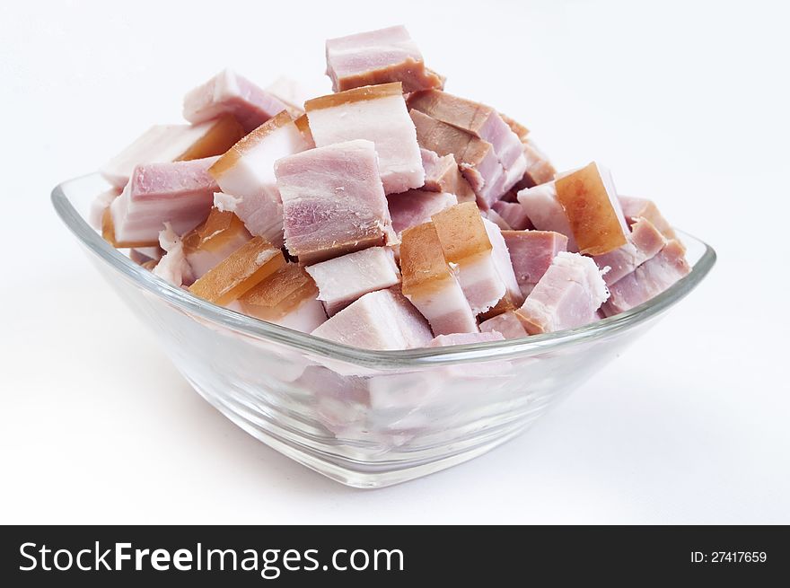 Bacon close up in glass bowl on white background