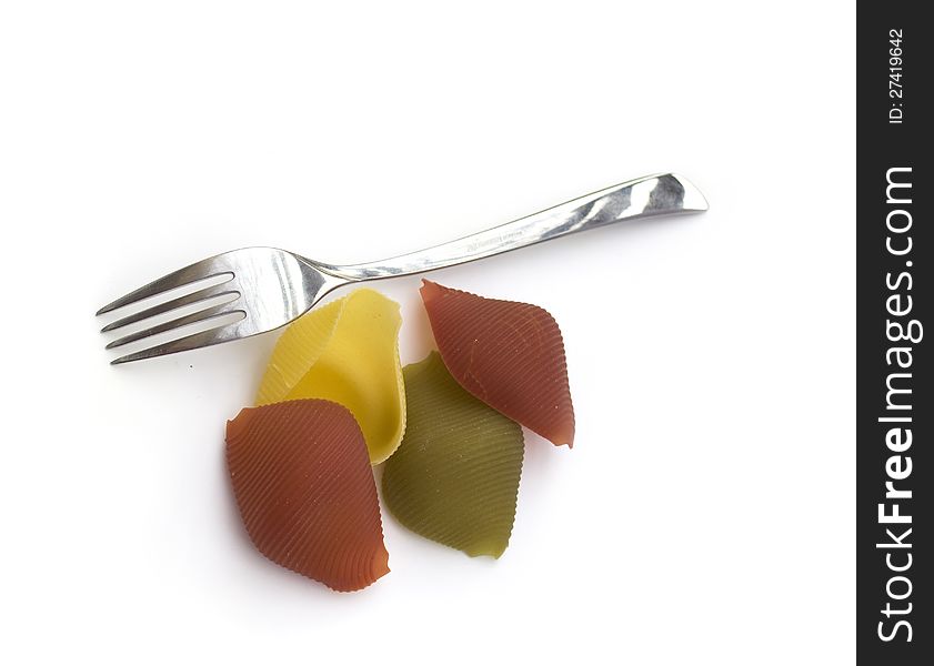 Colored conchiglioni pasta with fork isolated on white. Colored conchiglioni pasta with fork isolated on white