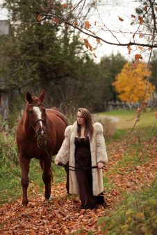 Formal Young Lady Walking Her Horse Royalty Free Stock Images