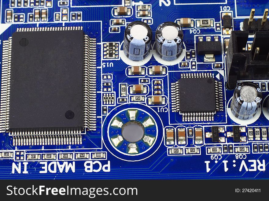 Digital hardware closeup. Microchips and condensers assembly on the circuit board macro. Digital hardware closeup. Microchips and condensers assembly on the circuit board macro