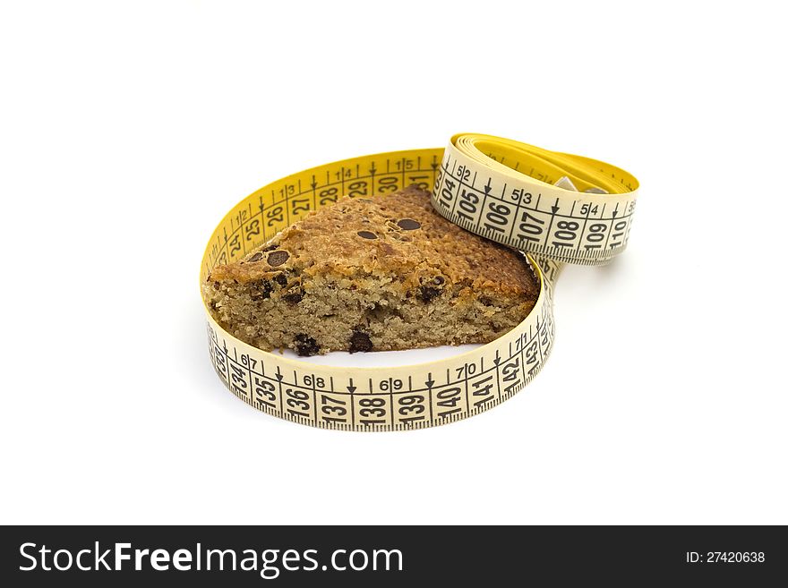 Unhealthy eating concept: cake and measure tape. Unhealthy eating concept: cake and measure tape