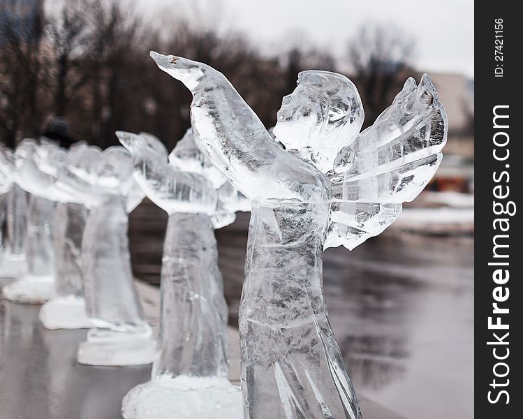 Icy sculpture of frozen angel in winter city. Icy sculpture of frozen angel in winter city