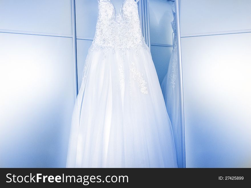 White wedding dress near the mirror