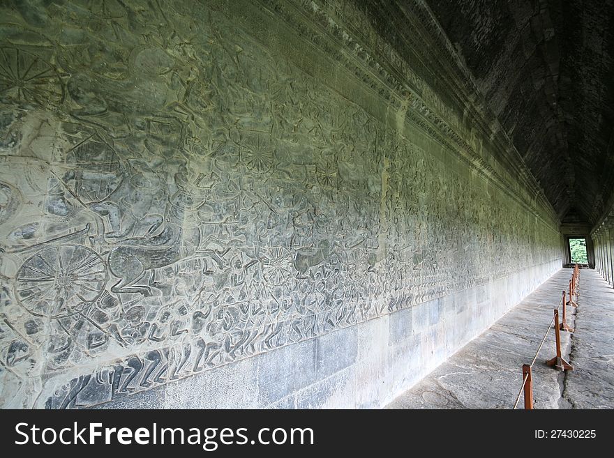 Long wall full of bas reliefs at the Angkor Wat temple in Cambodia