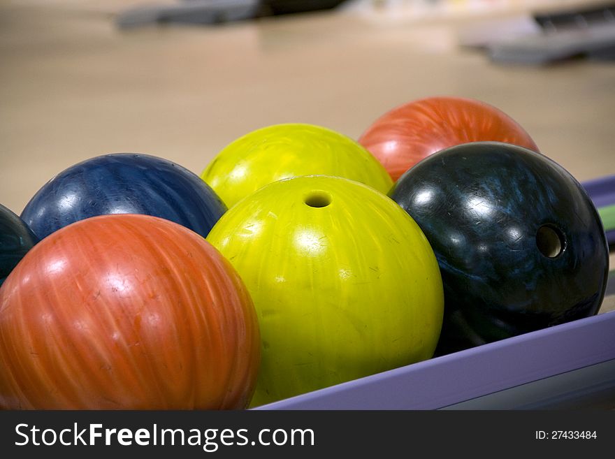 Colorful bowling balls on shelf