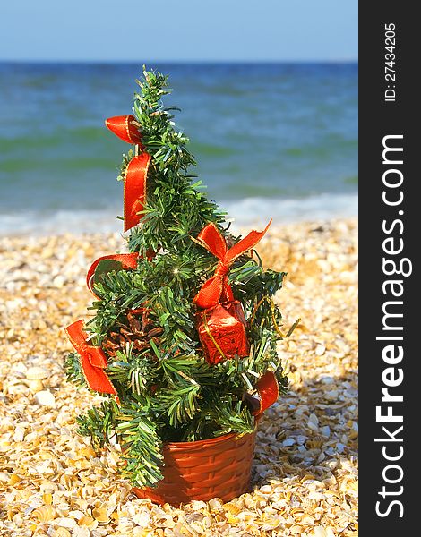 Festively decorated Christmas tree on the beach