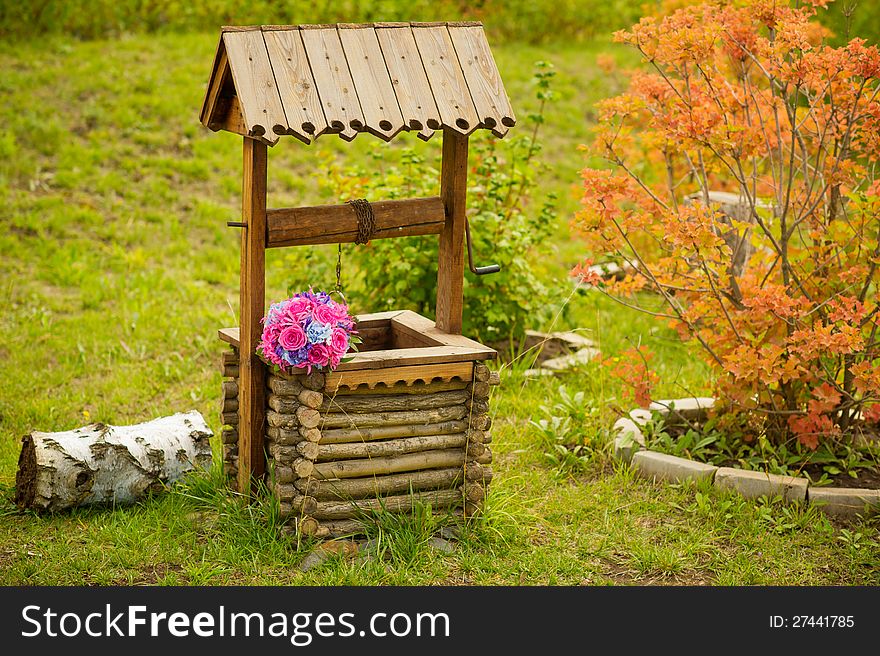 Coutryside autumn view with wedding bouquet on the well