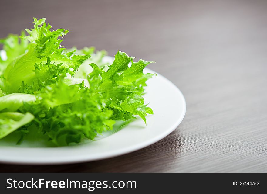 Green lettuce on a plate close-up macro.