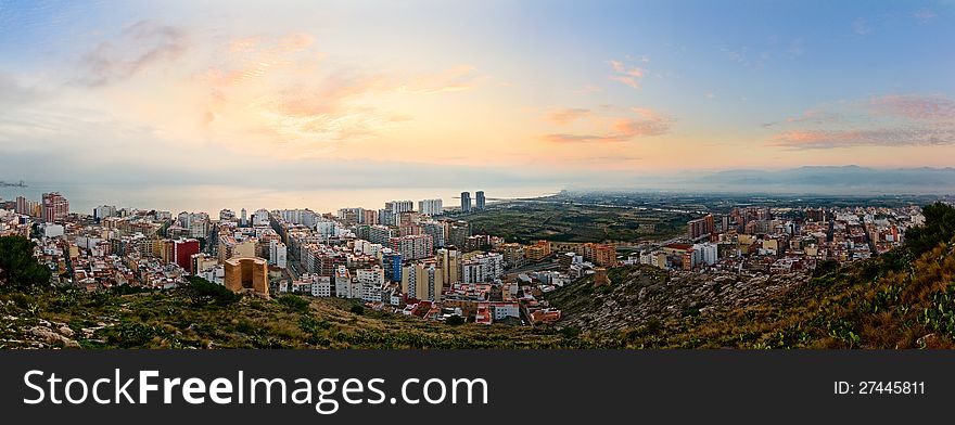 Panoramic view on a small spanish city Cullera (Valencia, Spain) at sunrise. Panoramic view on a small spanish city Cullera (Valencia, Spain) at sunrise