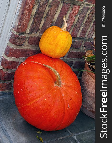 Two orange colored pumpkins decorations. Two orange colored pumpkins decorations
