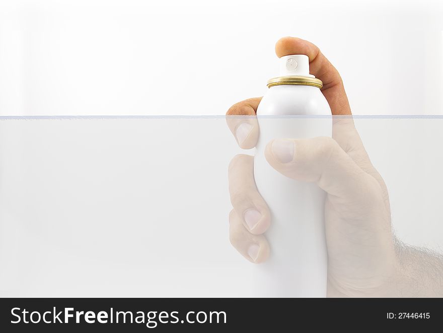 Hand holding spray can over white background. Hand holding spray can over white background