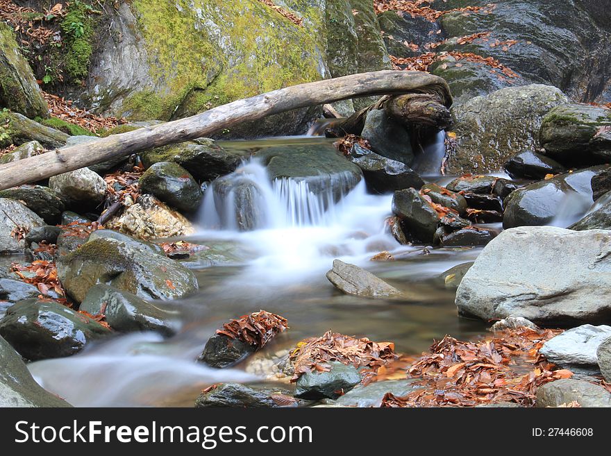 The picture of running water taken in the autumn.