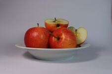 Red Apples On A White Plate, Half An Apple, White Plate, Red Apples Royalty Free Stock Images