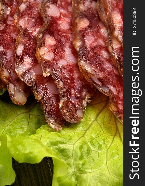 Slices of Smoked Sausage on Lettuce closeup