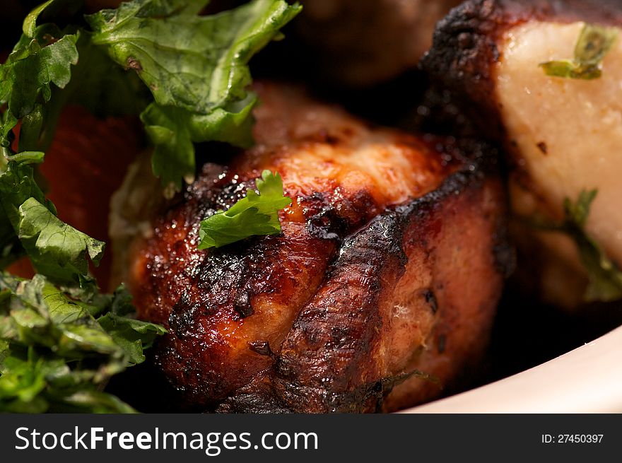 Portion of Perfect Ripe Pork Kebab closeup with Greens