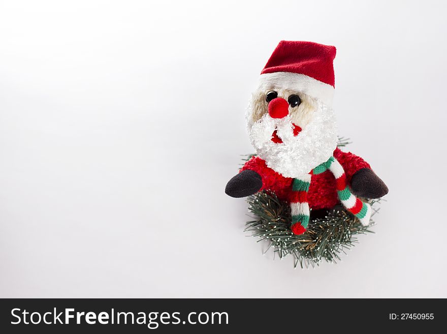 Little Toy Santa Claus in fir tree wreath