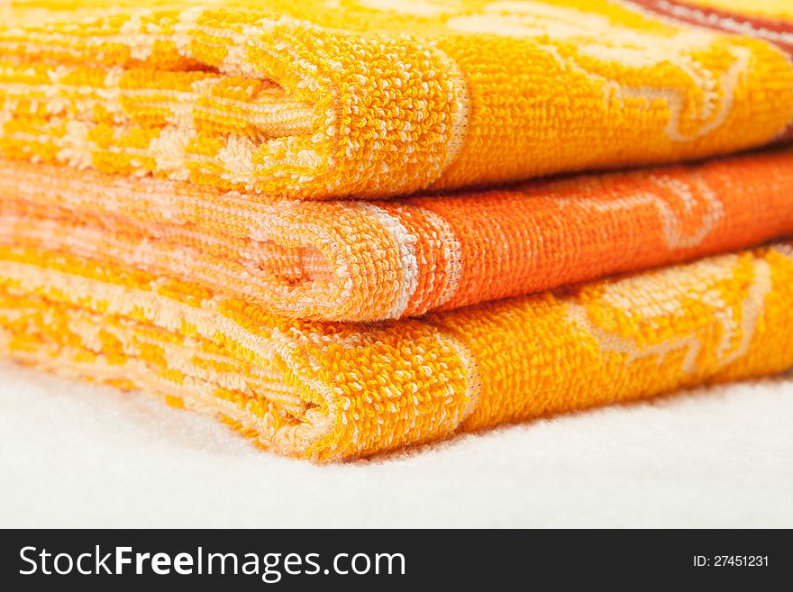 Orange and yellow Towels over white white