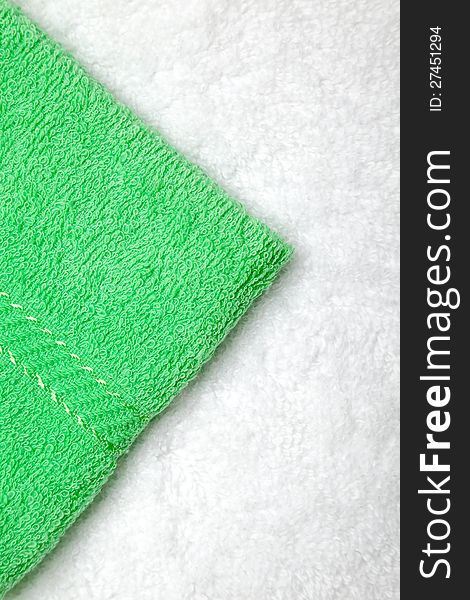 Green small towel or napkin over white. Green small towel or napkin over white