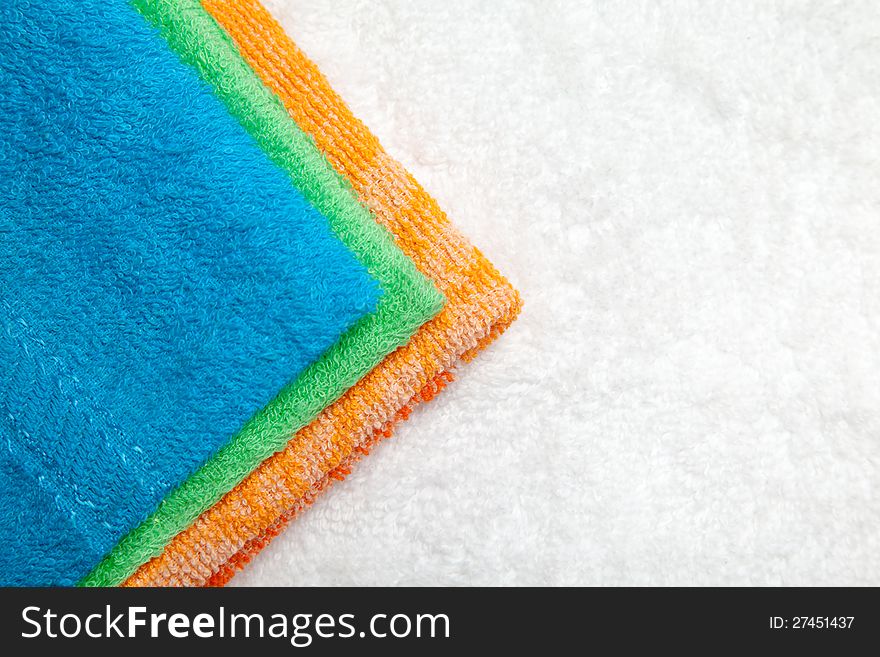 Stacked colorful towels isolates over white. Stacked colorful towels isolates over white