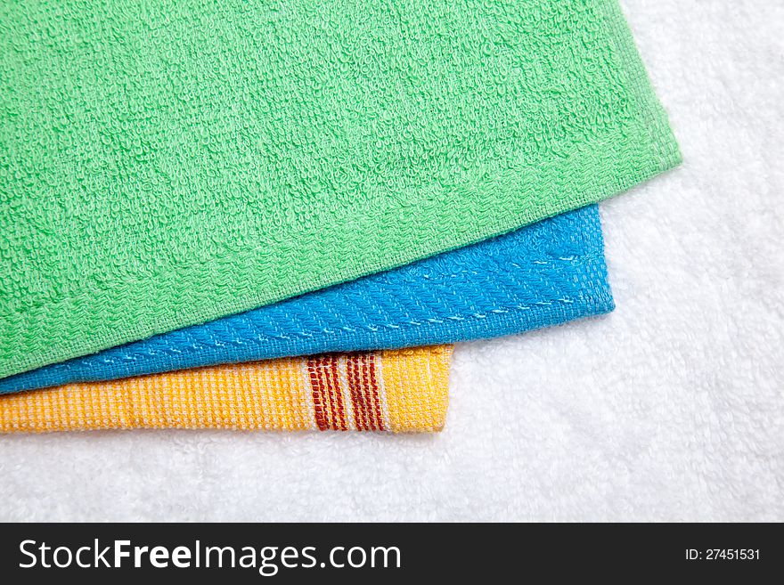 Stacked colorful towels isolates over white. Stacked colorful towels isolates over white
