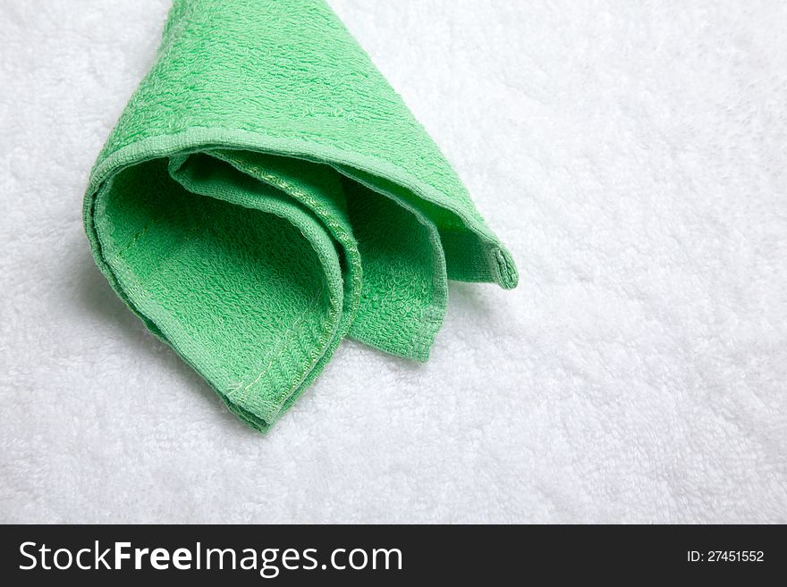 Green small  towel  over white. Green small  towel  over white