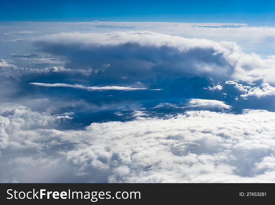 Beautiful view on high blue sky background with clouds