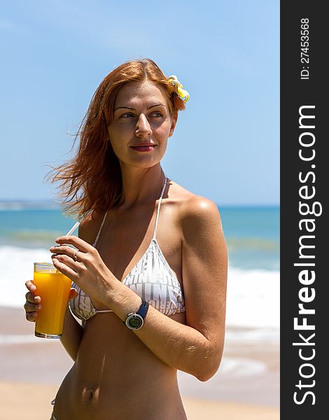 Closeup of slim woman body in black bikini on beach