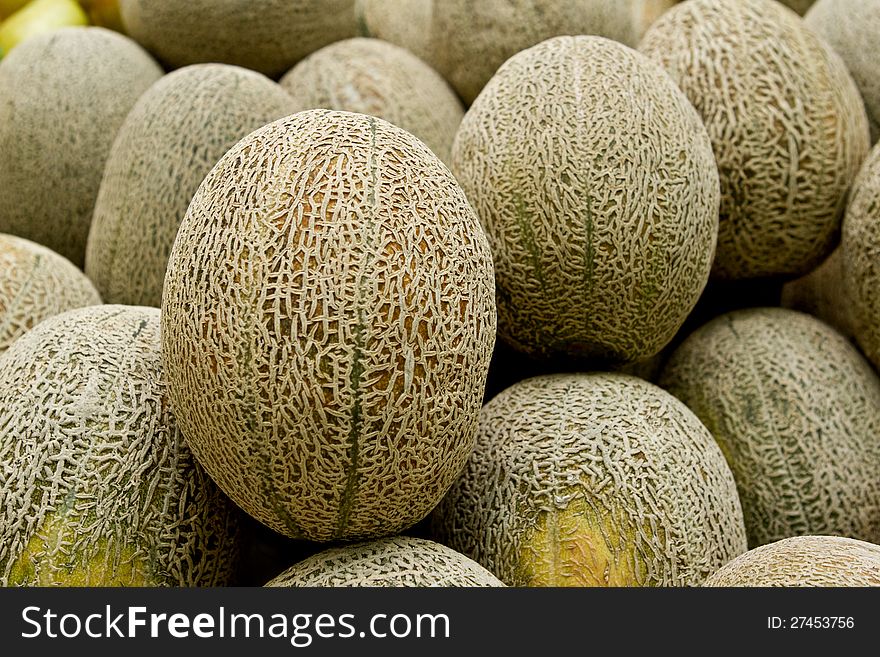 Piles of Rock melon display in market.