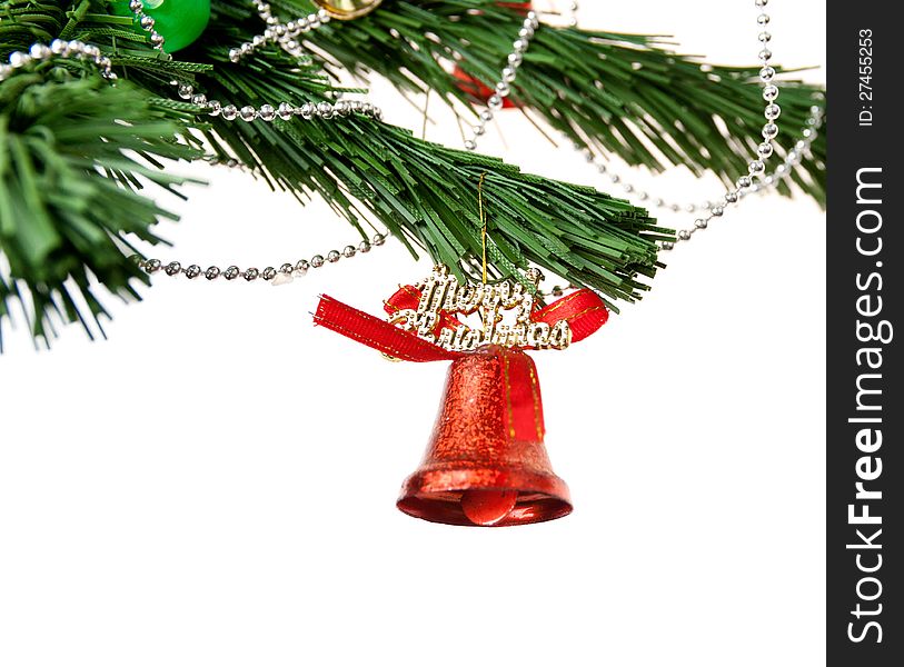 Christmas bell and new year beads on the branch of a tree on a white background. Christmas bell and new year beads on the branch of a tree on a white background