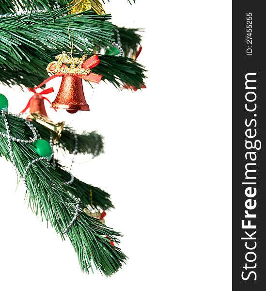 Christmas bell and new year beads on the branch of a tree on a white background