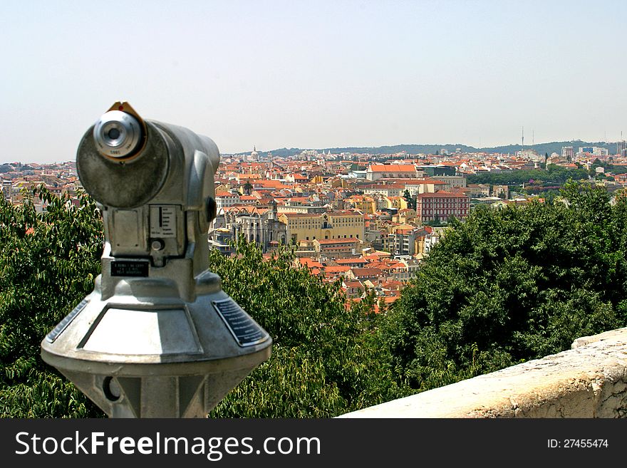 View to Lisbon city in Portugal from castelo de S. Jorge . Tourist can use a local binocular to see the details in landscape. View to Lisbon city in Portugal from castelo de S. Jorge . Tourist can use a local binocular to see the details in landscape